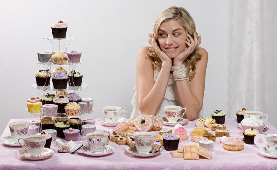 woman-with-table-of-tea-and-cakes